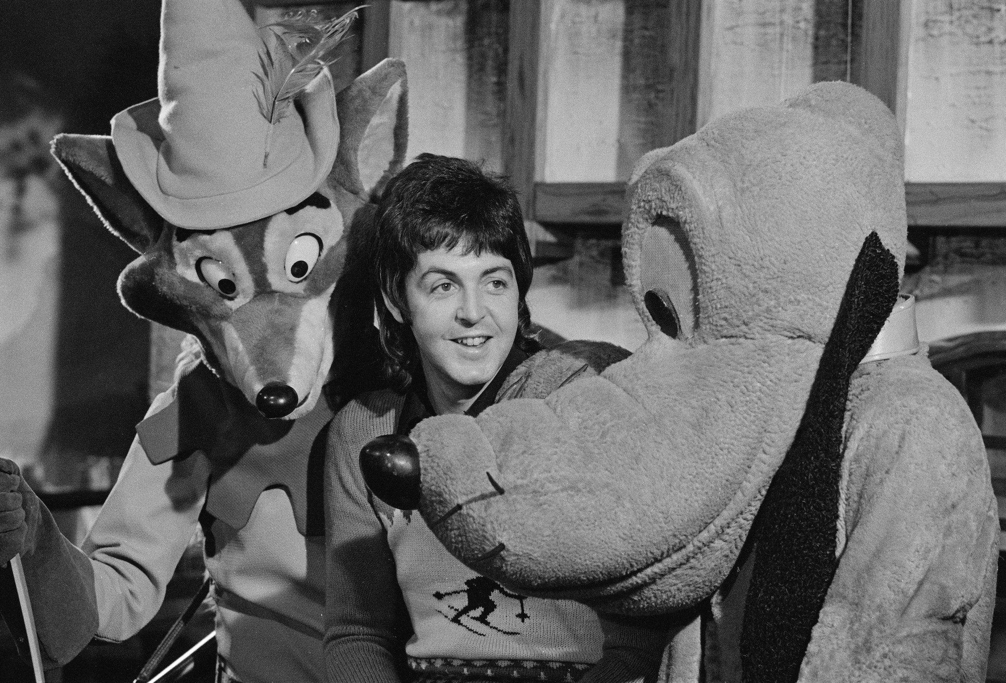 Paul McCartney poses with Disney characters Robin Hood and Pluto in 1973