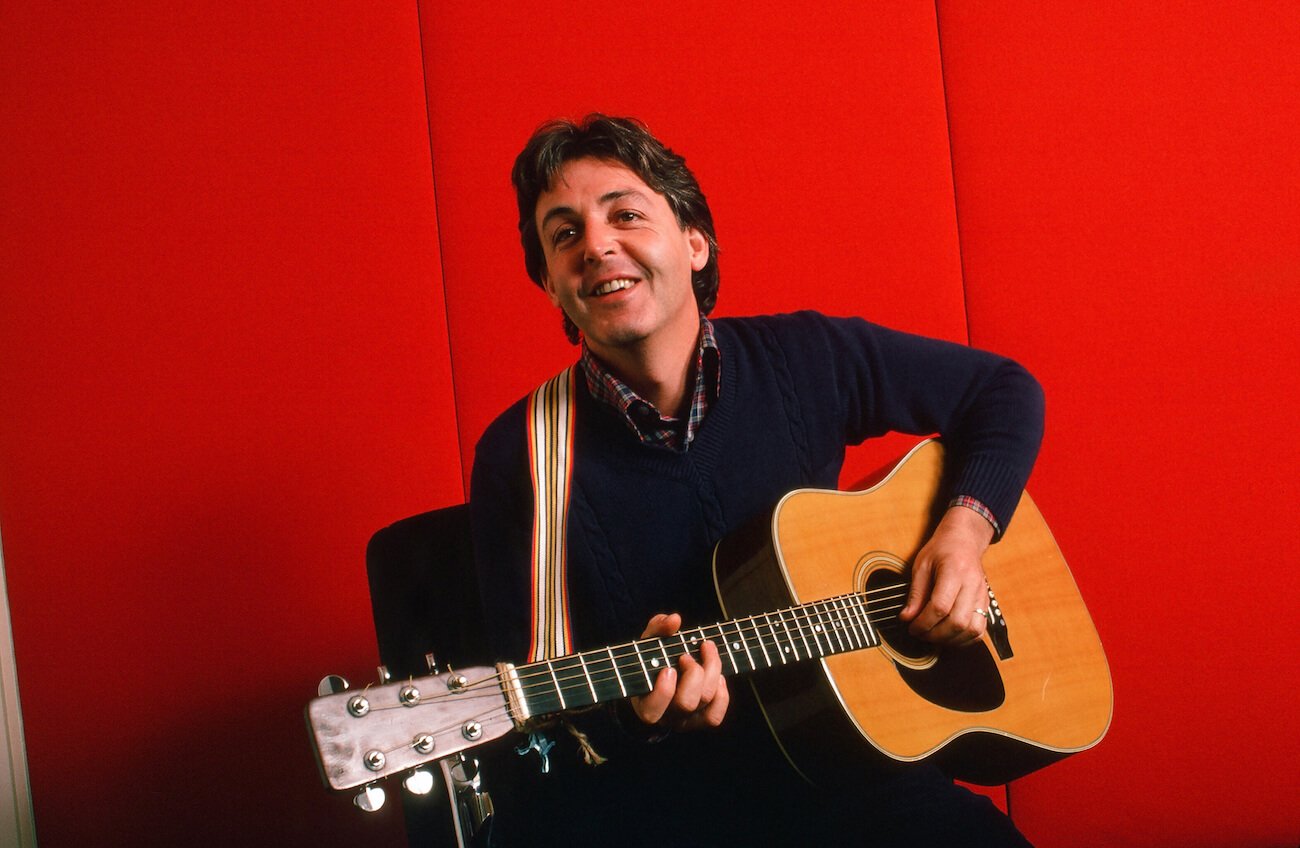 Paul McCartney playing acoustic guitar in 1984.