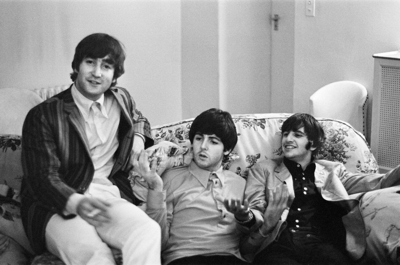 The Beatles sitting on a couch in 1964.