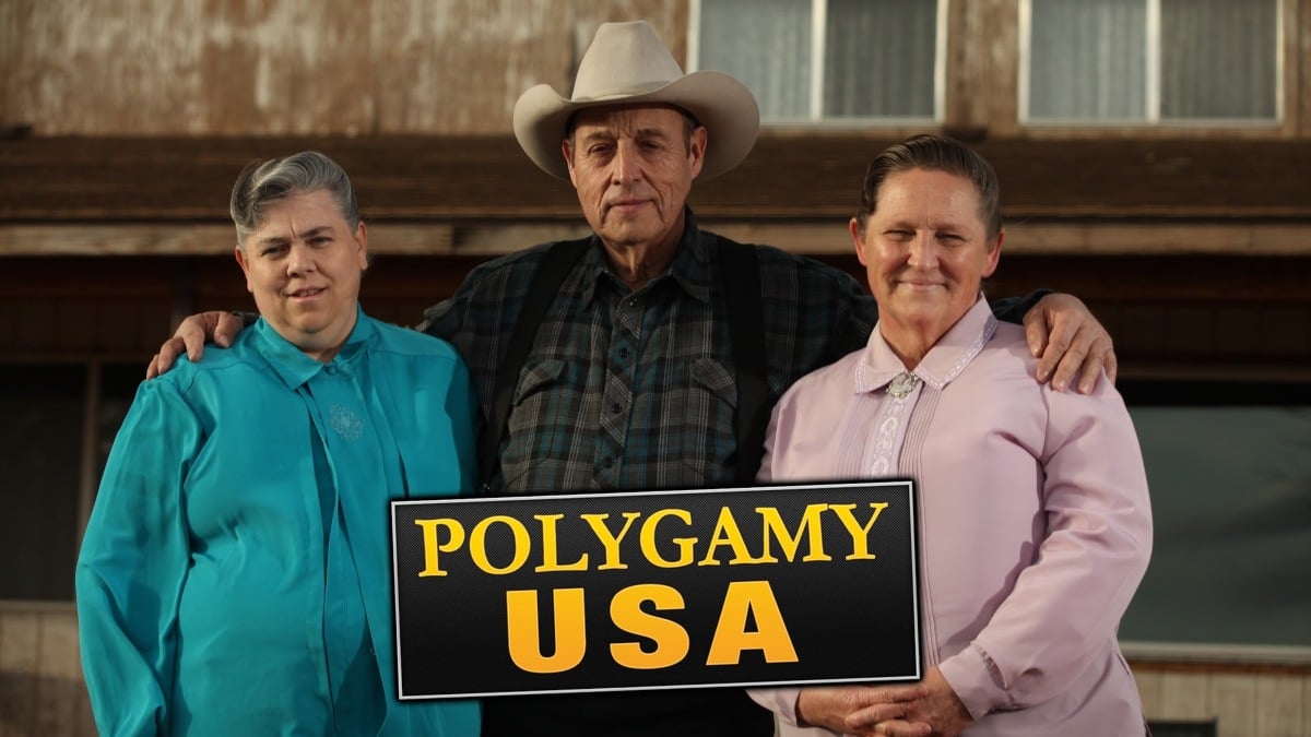 Arthur and his two wives, Gloria and Marlyne stand outside their home in Centennial Park, AZ as featured on 'Polygamy, USA'.

