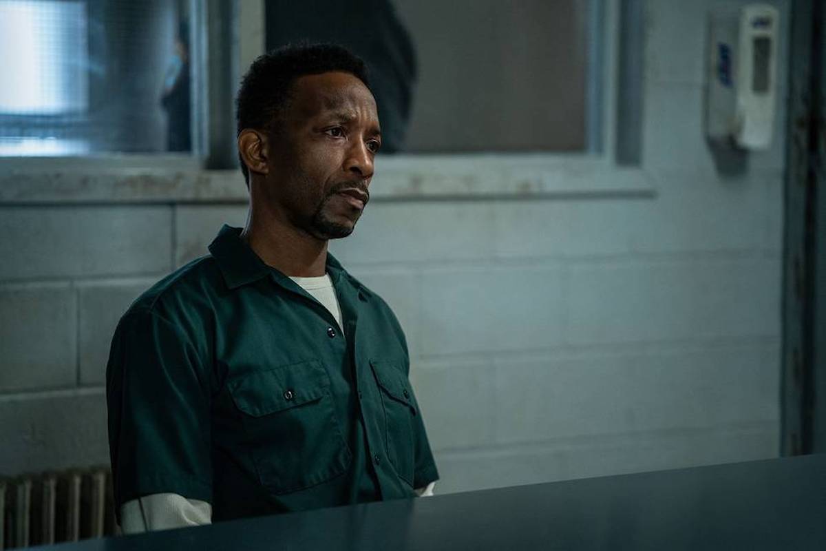 Jordan Mahome as Theo Rollins sitting in prison at a table in 'Power Book II: Ghost'