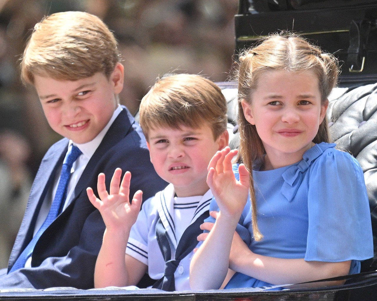 Prince George, Prince Louis, and Princess Charlotte sit together during a royal engagement.