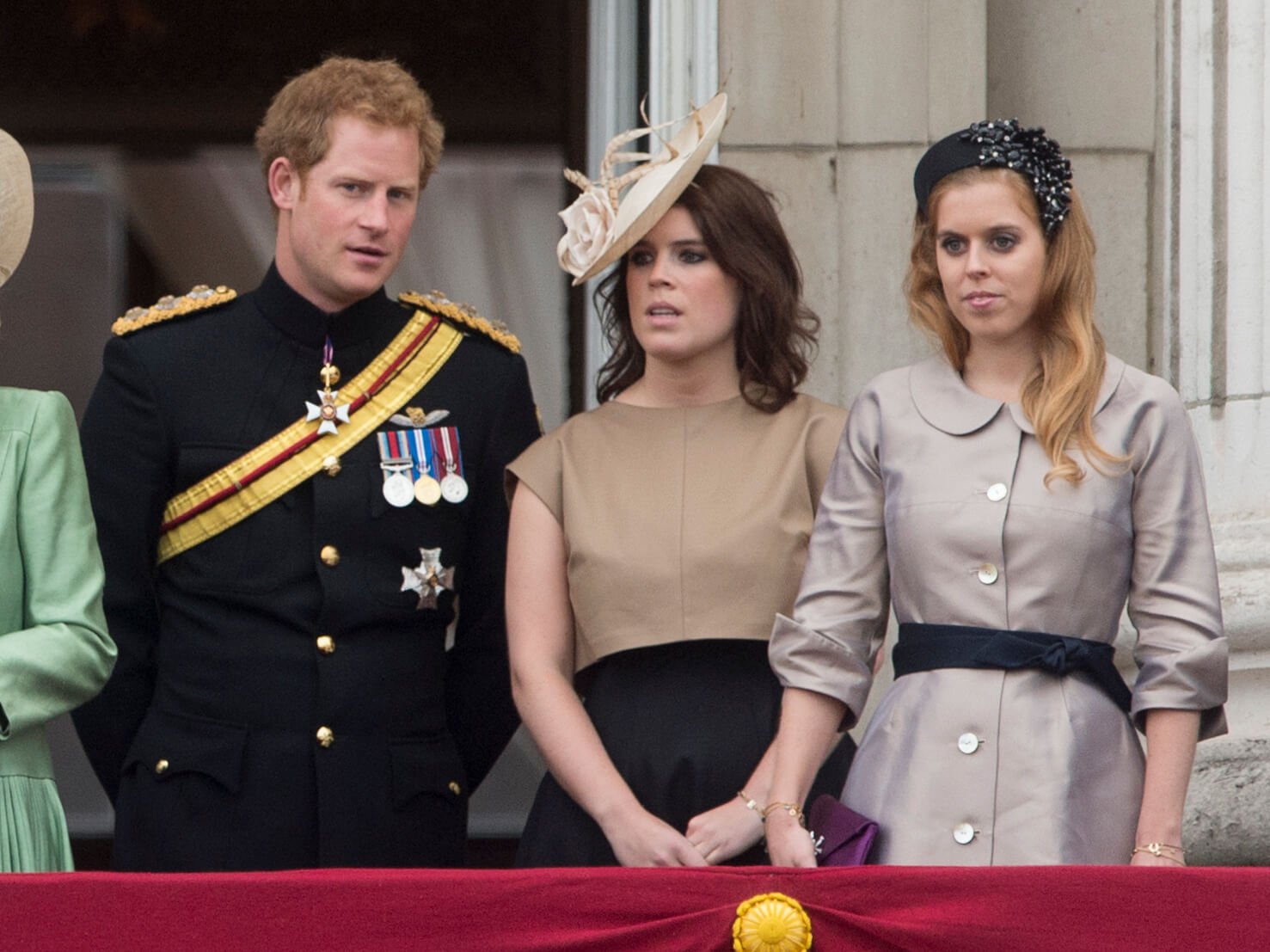 Prince Harry, Princess Eugenie, and Princess Beatrice of the royal family standing next to each other