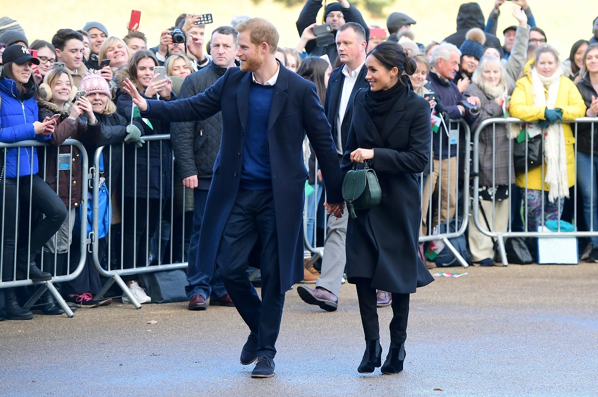 Prince Harry and Meghan Markle are seen during a walkabout at Cardiff Castle