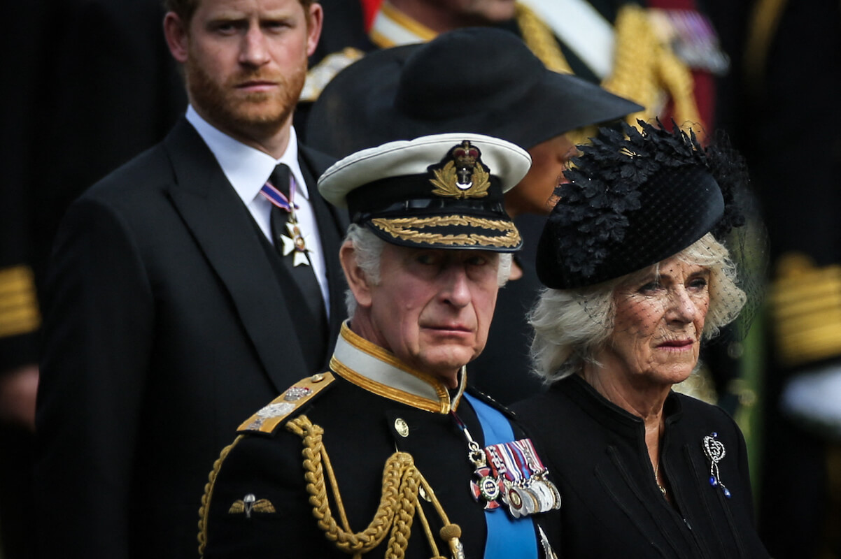 Camilla Parker Bowles, whose 'Spare' reaction reportedly included an 'eye-roll,' stands with Prince Harry, Meghan Markle, and King Charles III