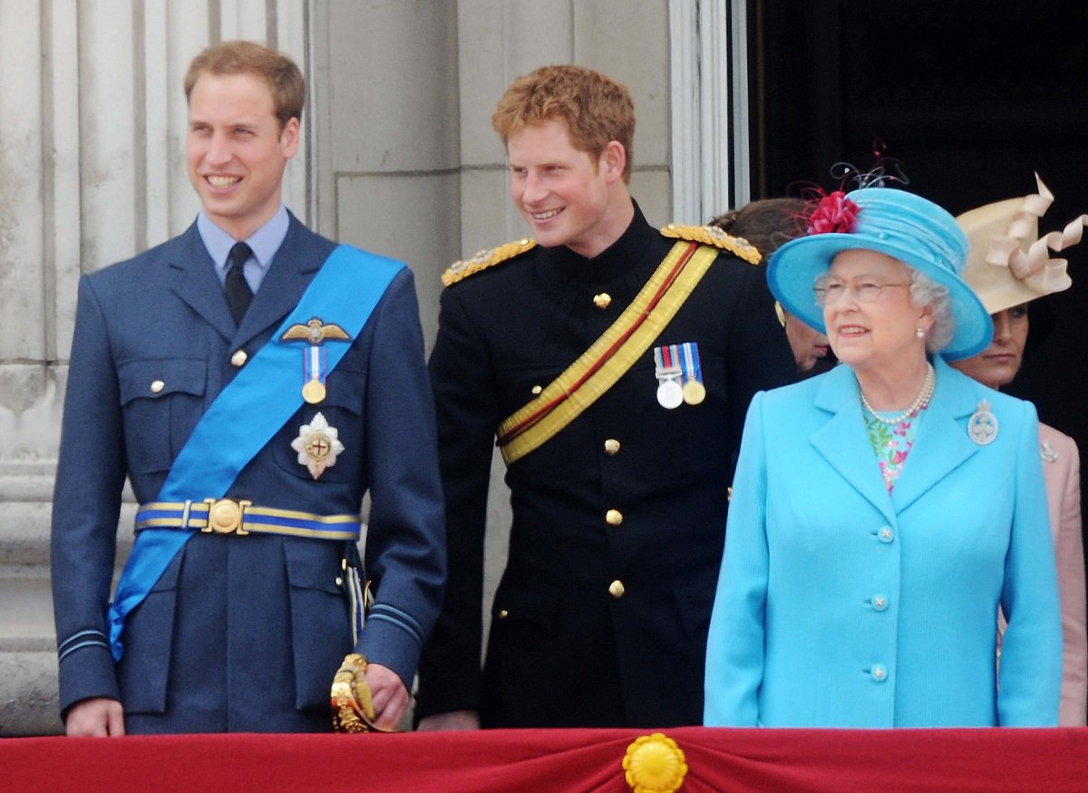 Prince William, Prince Harry, and Queen Elizabeth II watch a fly past from the balcony of Buckingham Palace