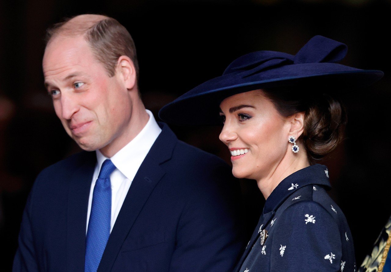 Prince William and Kate Middleton smile during a royal engagement.