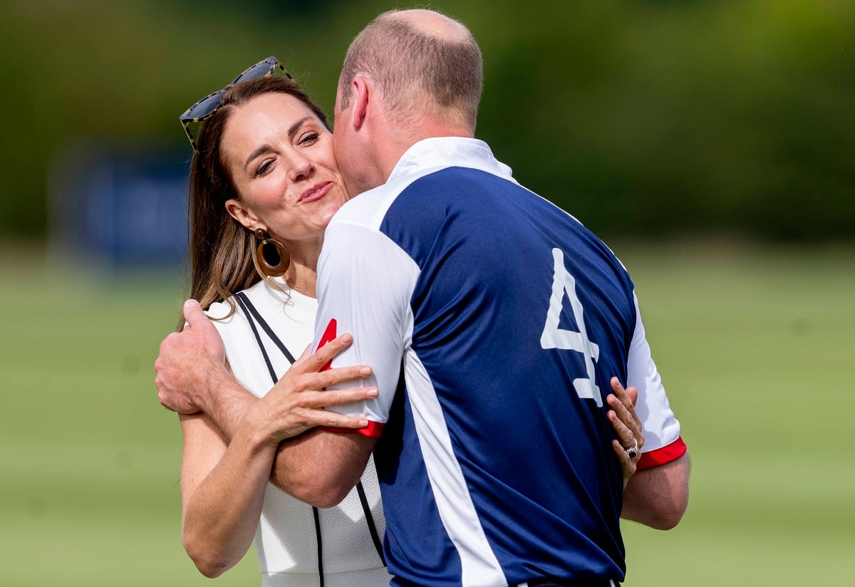 Prince William and Kate Middleton embrace during the prize presentation at the Out-Sourcing Inc. Royal Charity Polo Cup