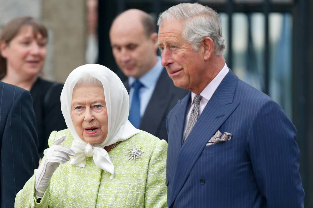 King Charles III, who may host a more 'relaxed' Easter dinner in 2023, stands with Queen Elizabeth II