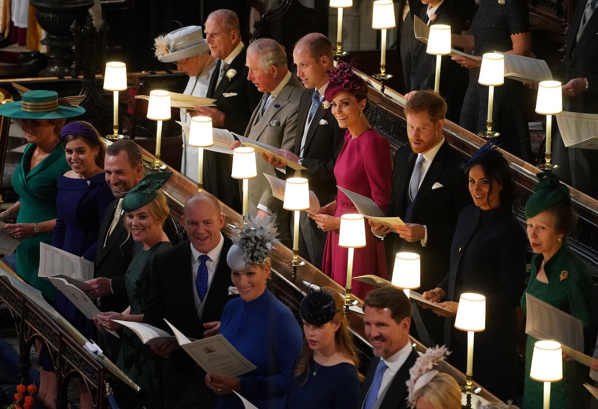 Queen Elizabeth II stands with her children and grandchildren, among them Zara Tindall and Mike Tindall, the 'sexiest royal couple,' at Princess Eugenie's wedding