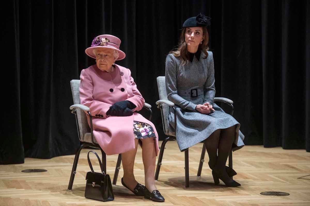 Kate Middleton, whose years of 'dressing too old for her age' have made her image a 'constant, according to a historian, sits next to Queen Elizabeth II 