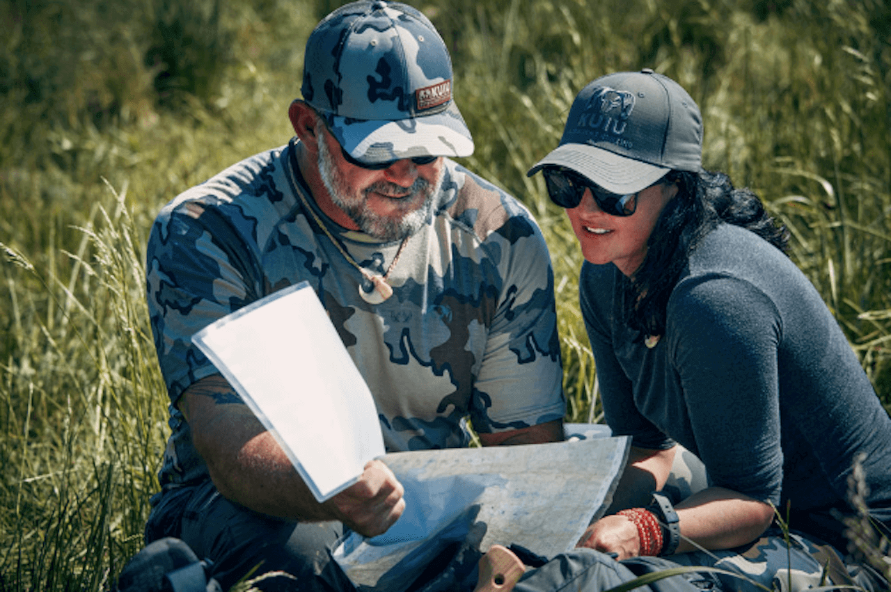 Brett Gatten and Esther Sunderlin look at a map on 'Race to Survive Alaska'.