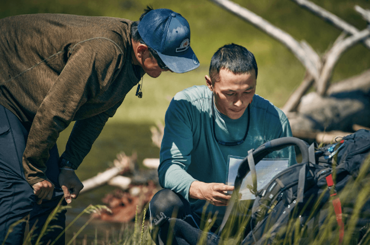 Oliver Hoogendorn and Wilson Hoogendorn look at a map on 'Race to Survive Alaska'.