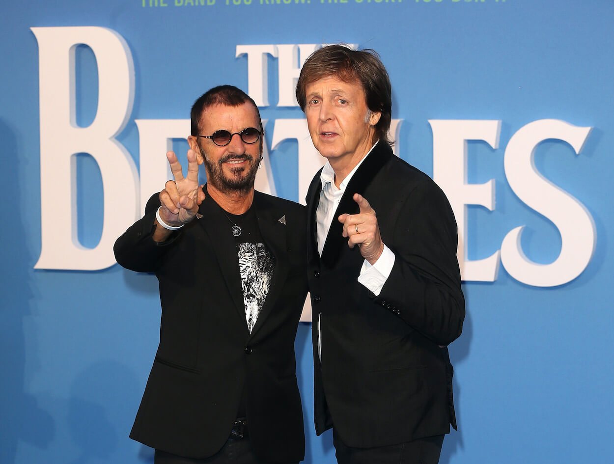 Ringo Starr (left) flashes a peace sign and Paul McCartney points toward the camera at the 2016 premier of 'The Beatles: Eight Days a Week.'