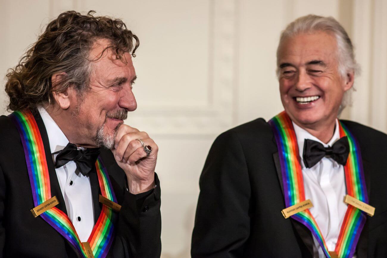 Robert Plant and Jimmy Page wear rainbow ribbons and tuxedos.