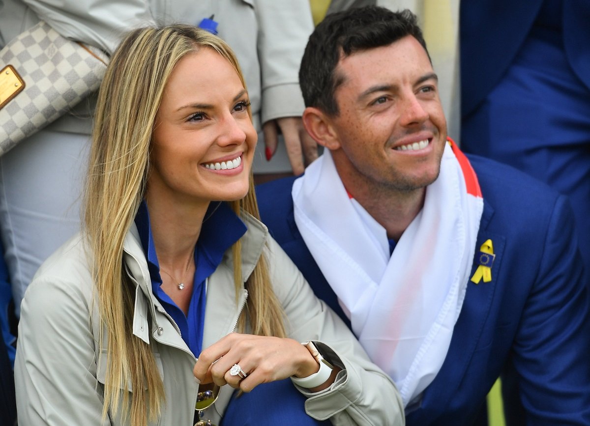 Rory McIlroy smiling with his wife Erica after winning the Ryder Cup at Le Golf National in Paris