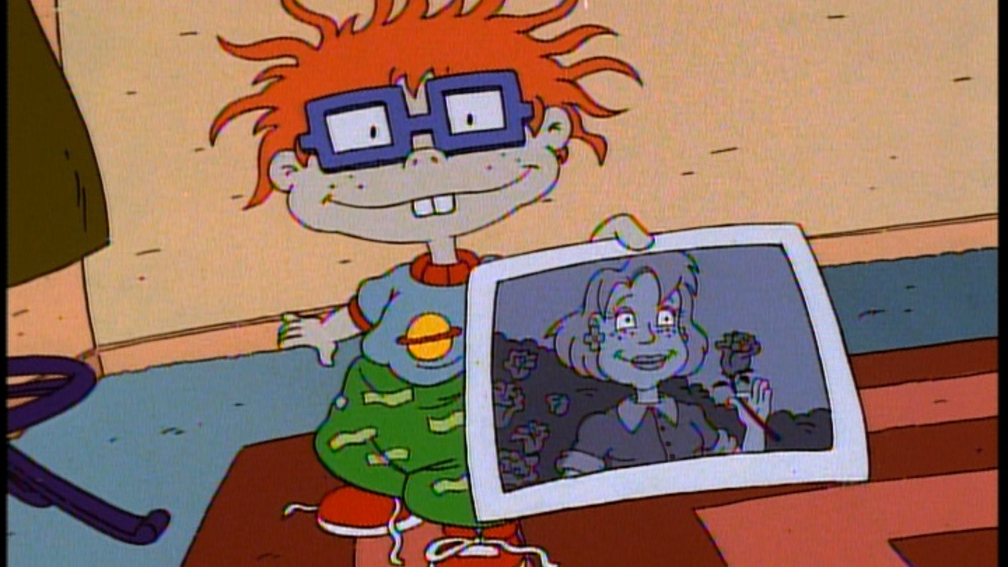 'Rugrats' Chuckie Finster holding a black-and-white photograh of a woman holding a flower.