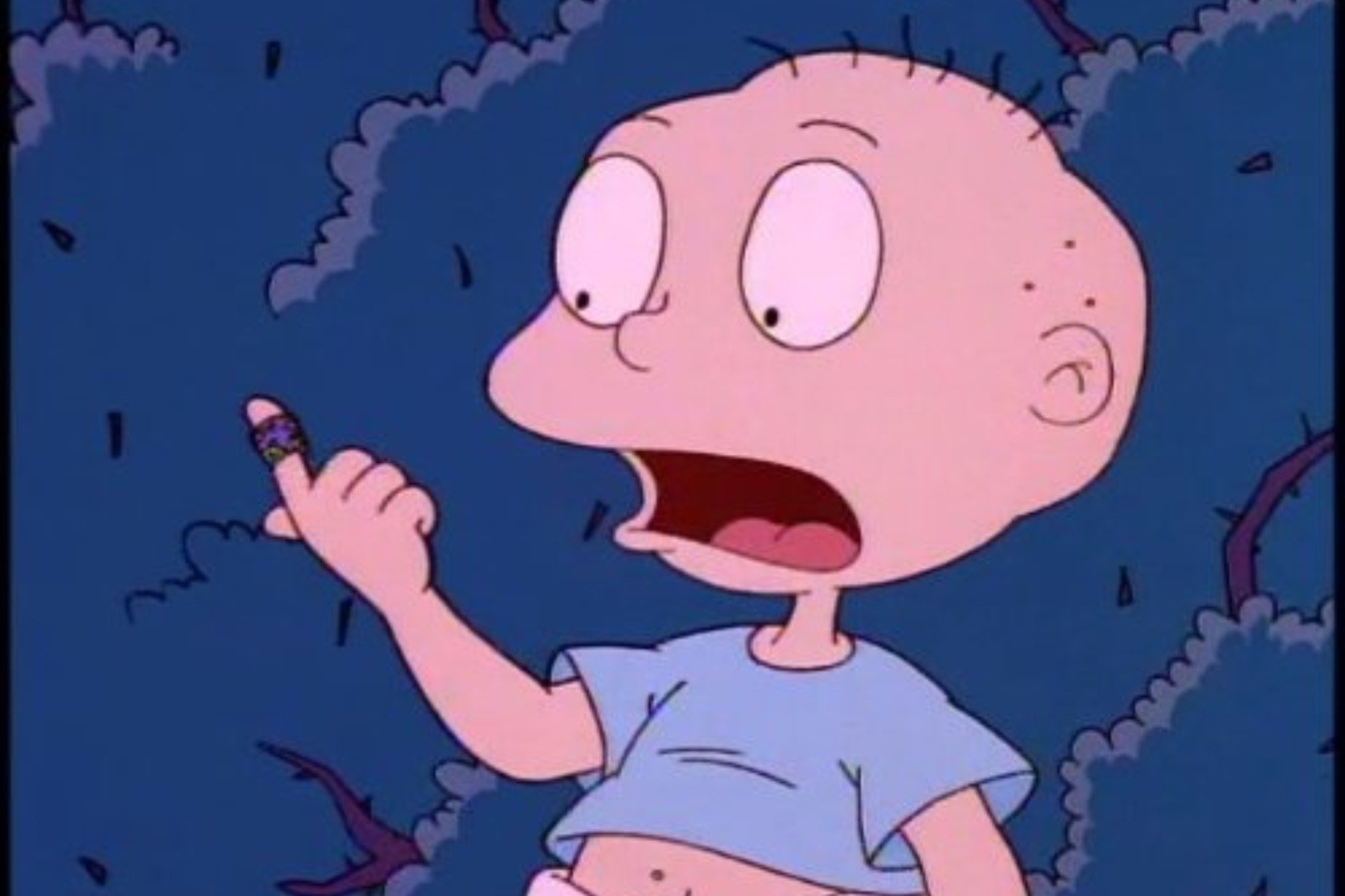'Rugrats' Tommy voice actor Elizabeth Daily holding up his wrapped finger, with his mouth open.