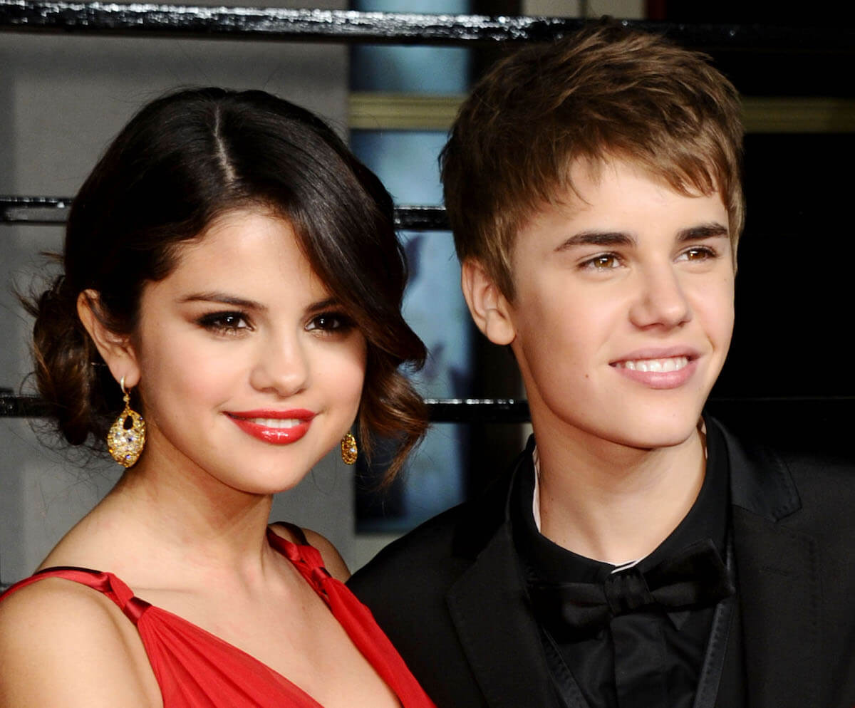 Selena Gomez and Justin Bieber all dressed up standing together and smiling