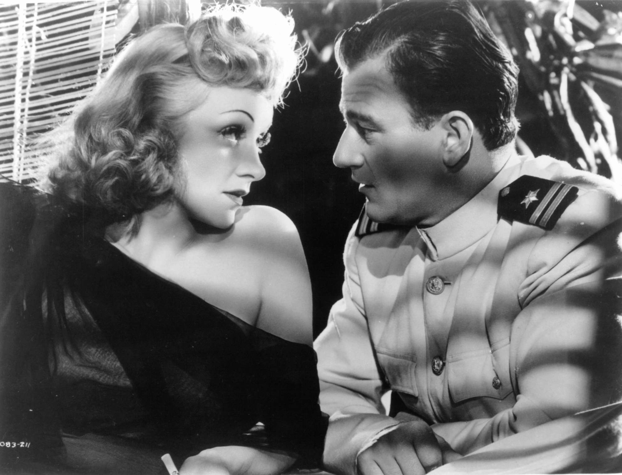 'Seven Sinners' Marlene Dietrich and John Wayne looking into each other's eyes.