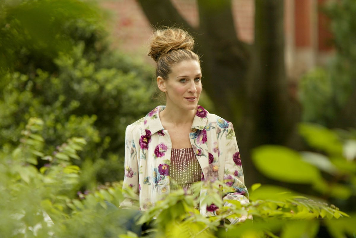 Sarah Jessica Parker as Carrie Bradshaw standing among plants in 'Sex and the City'
