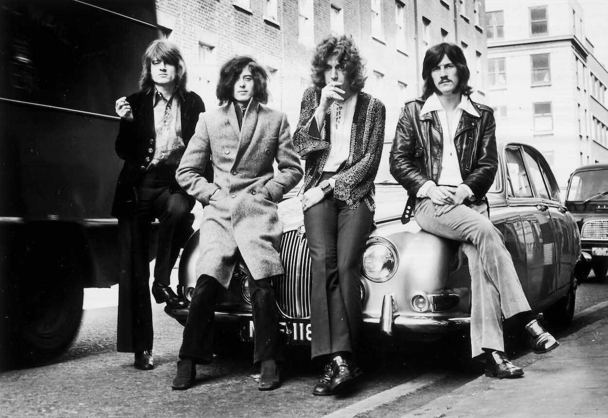 Led Zeppelin members (from left) John Paul Jones, Jimmy Page, Robert Plant, and John Bonham lean against a car during a December 1968 photo shoot.