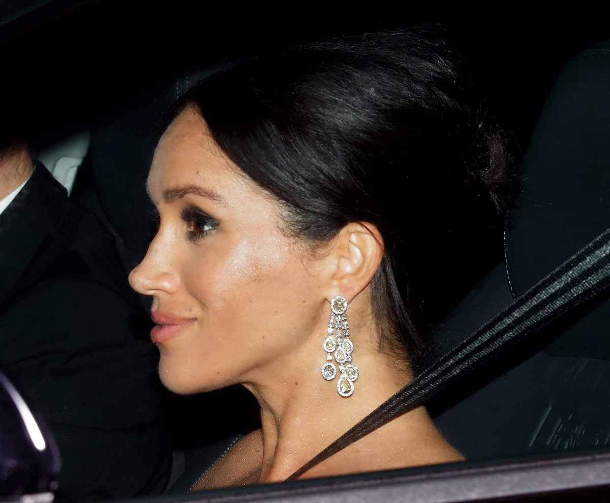 Side profile of Meghan Markle in a car headed to a party at Buckingham Palace