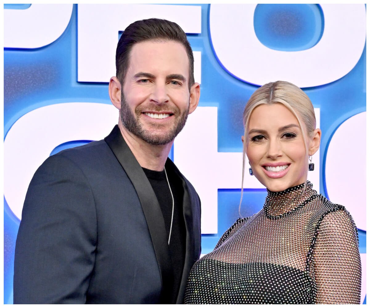 Tarek and Heather Rae El Moussa smile and pose together at an event.