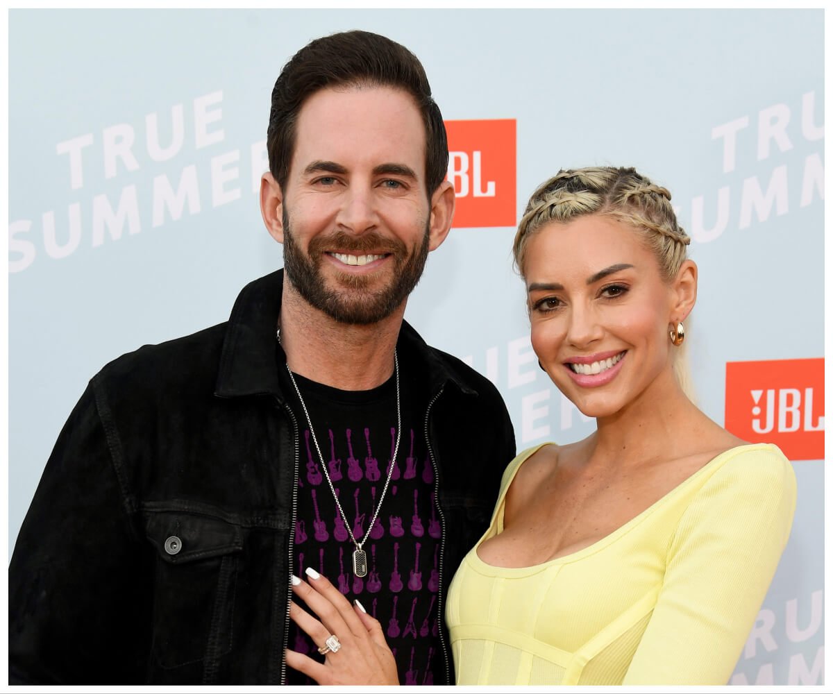 Tarek and Heather Rae El Moussa smile and pose together at and event.