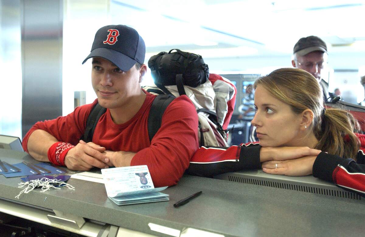 An engaged couple vie for airline tickets at LAX on The Amazing Race