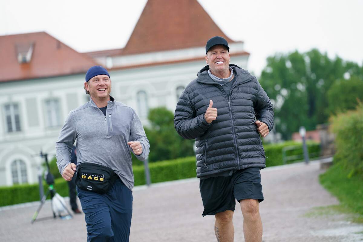 Rex Ryan and Tim Mann run during a challenge on The Amazing Race
