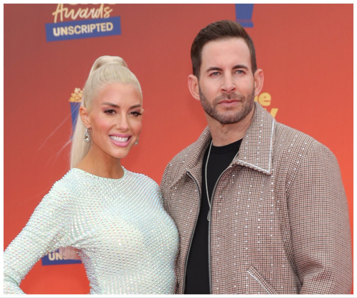 Tarek and Heather Rae El Moussa pose together at an event.