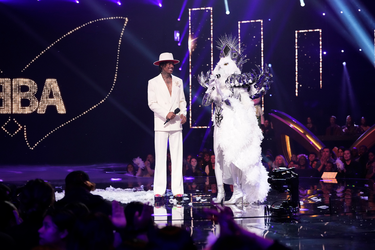 'The Masked Singer' Season 9 stage showing Nick Cannon with Debbie Gibson as Night Owl