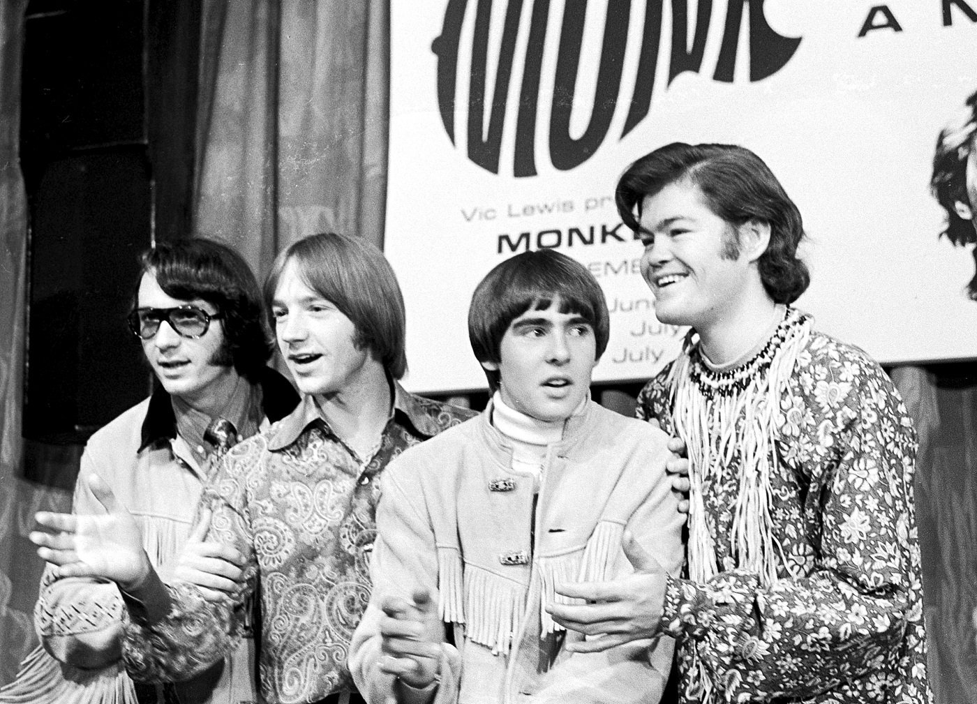 A black-and-white photo of Mike Nesmith, Peter Tork, Davy Jones, and Mickey Dolenz of The Monkees
