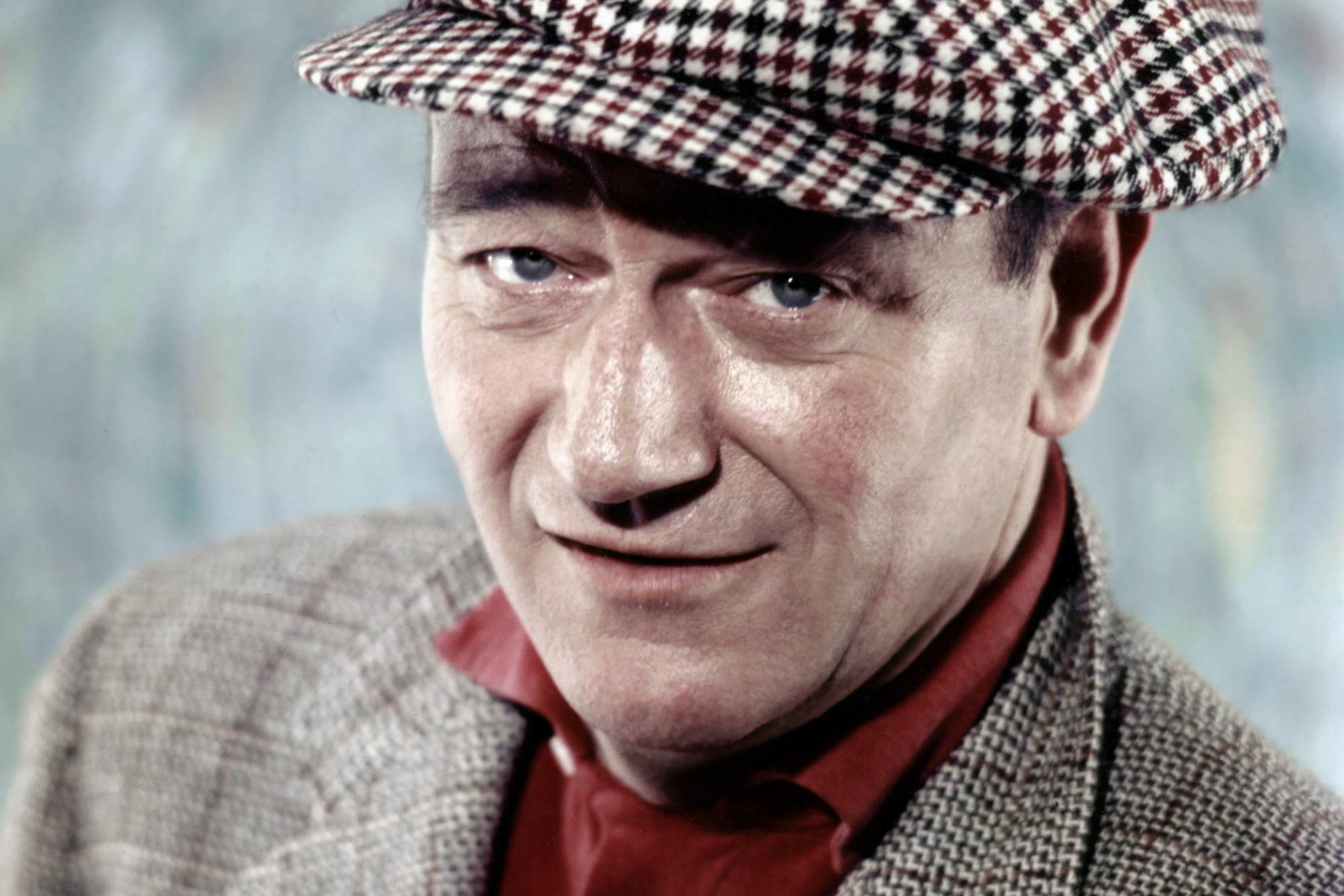 'The Quiet Man' John Wayne as Sean Thornton in a portrait wearing a hat and suit jacket.