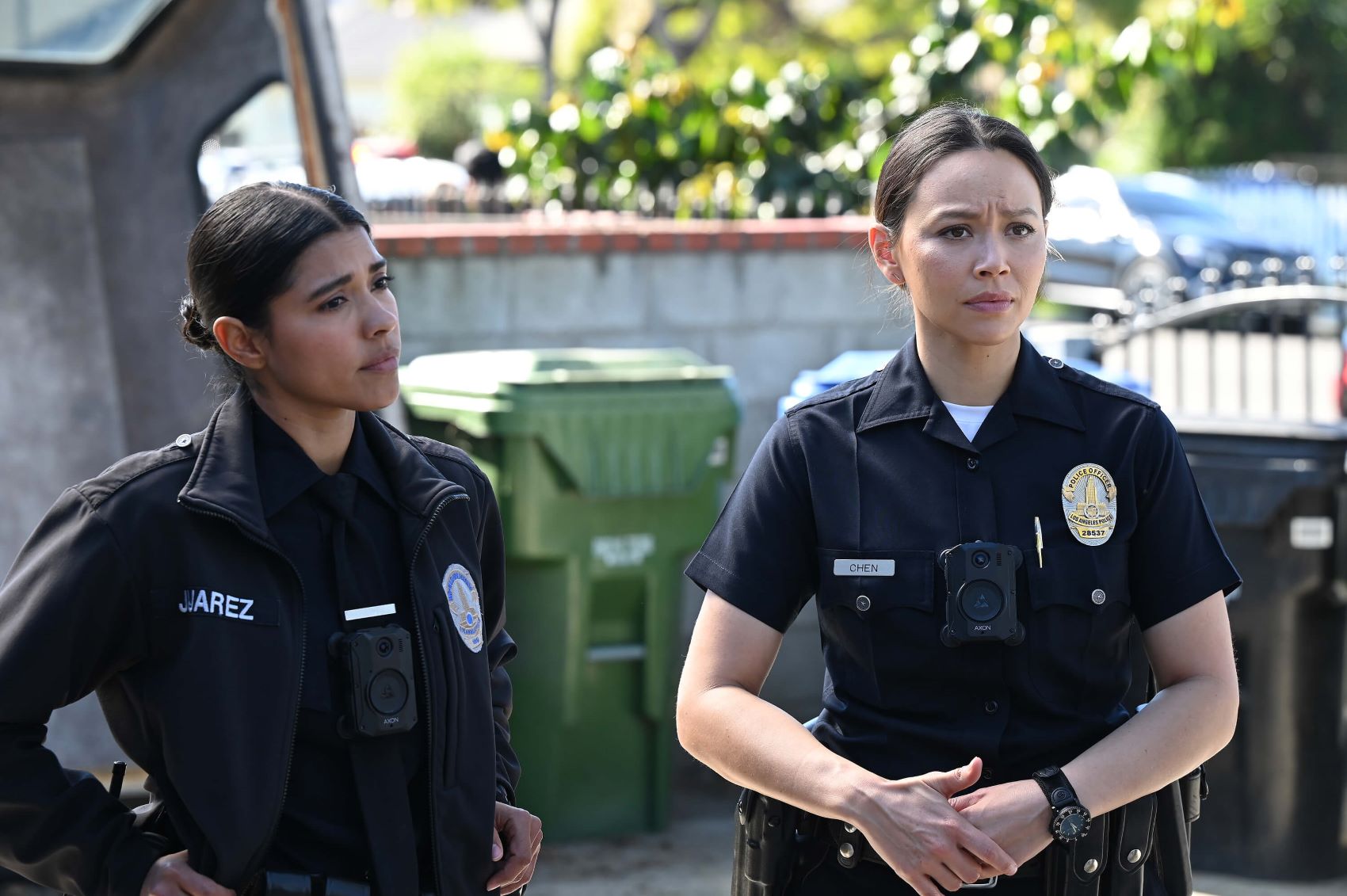 Lisseth Chavez as Celina Juarez and Melissa O'Neil as Lucy Chen share a scene in 'The Rookie' Season 5. In the photo, Celina and Lucy wear their dark blue police uniforms.