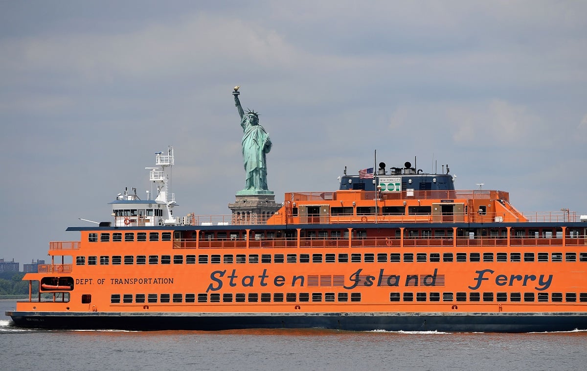 The Staten Island Ferry is seen in front of the Statue of Liberty in 2020