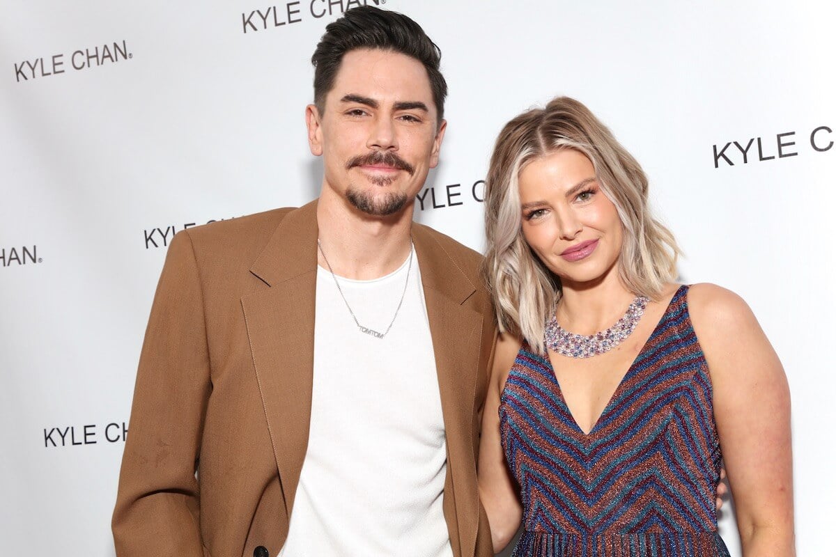 "Vanderpump Rules" stars Tom Sandoval and Ariana Madix smile and pose together at an event.