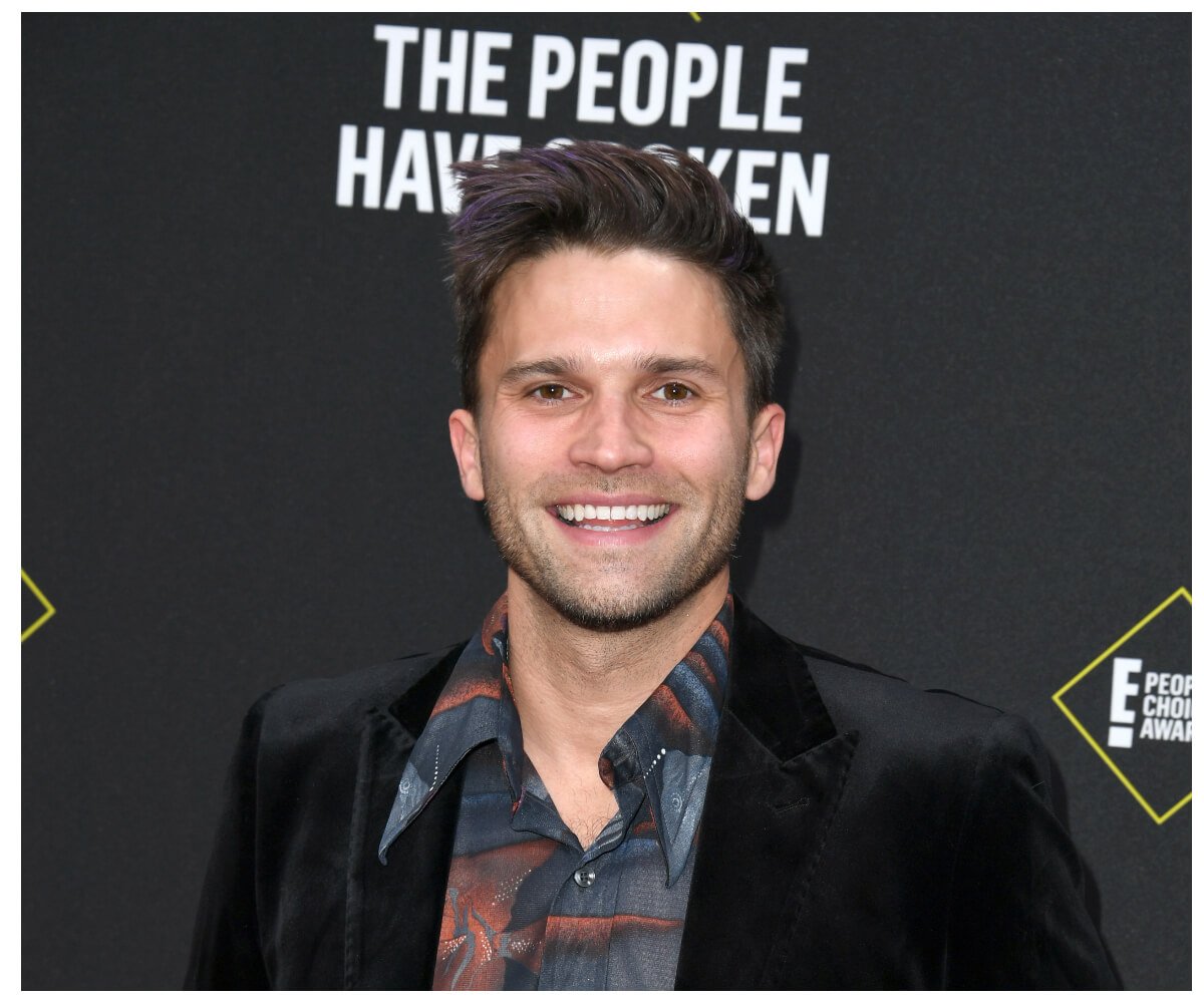"Vanderpump Rules" star Tom Schwartz smiles and poses at an event.
