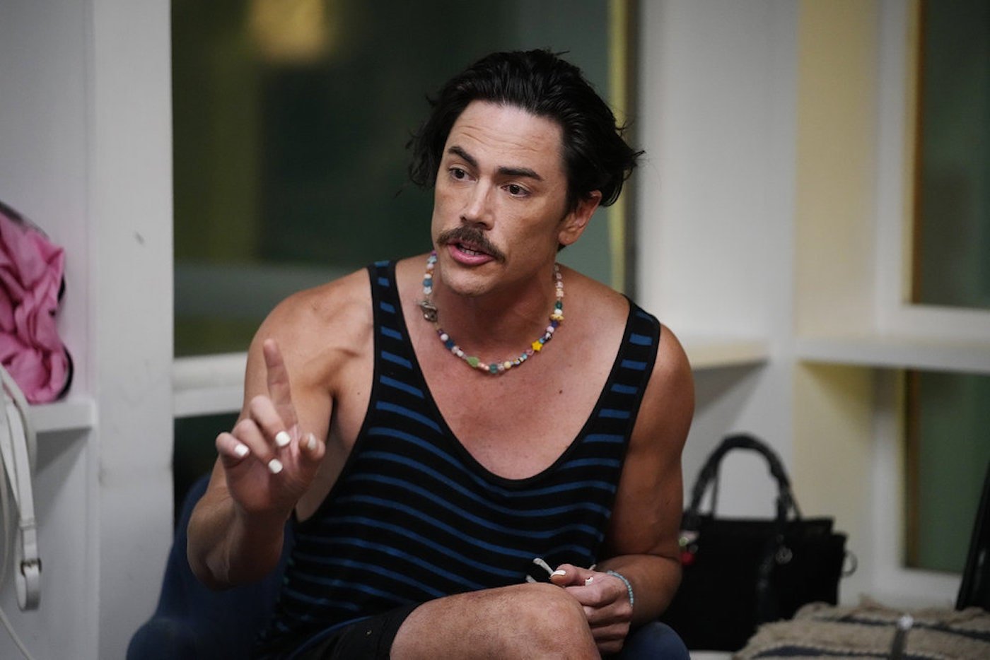Tom Sandoval from 'Vanderpump Rules' holds a finger up while wearing a tank top