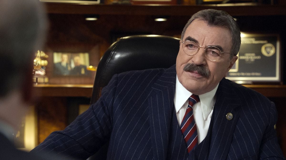 Tom Selleck looking serious in his office.