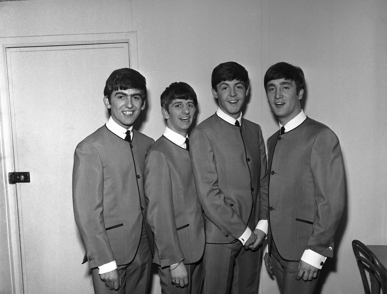 Beatles members (from left) George Harrison, Ringo Starr, Paul McCartney, and John Lennon wear matching suits in a 1963 band portrait.