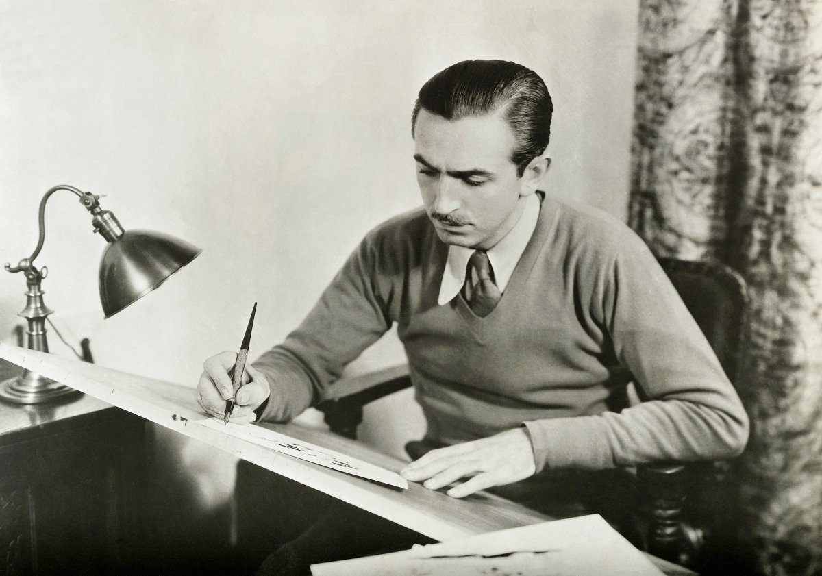 Walt Disney drawing at his desk in an undated photo