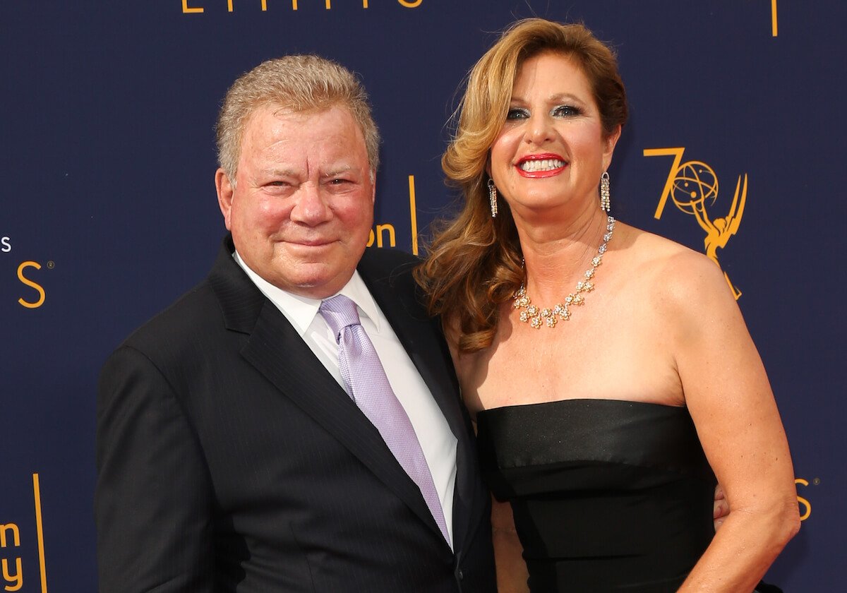 William Shatner and Elizabeth Martin standing together all dressed up and smiling