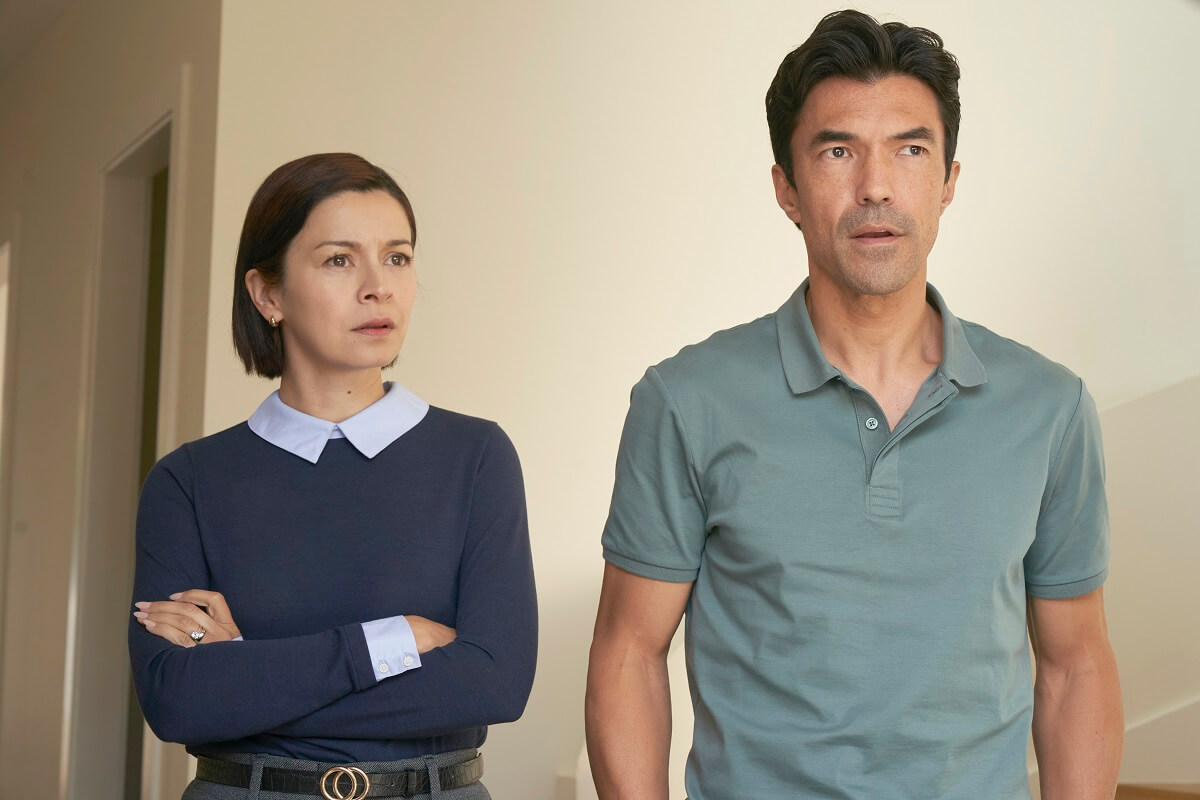 Accused Episode 11 cast members Julia Chan as Sarah standing with her arms crossed next to Ian Anthony Dale as Jiro, both looking ahead with concern
