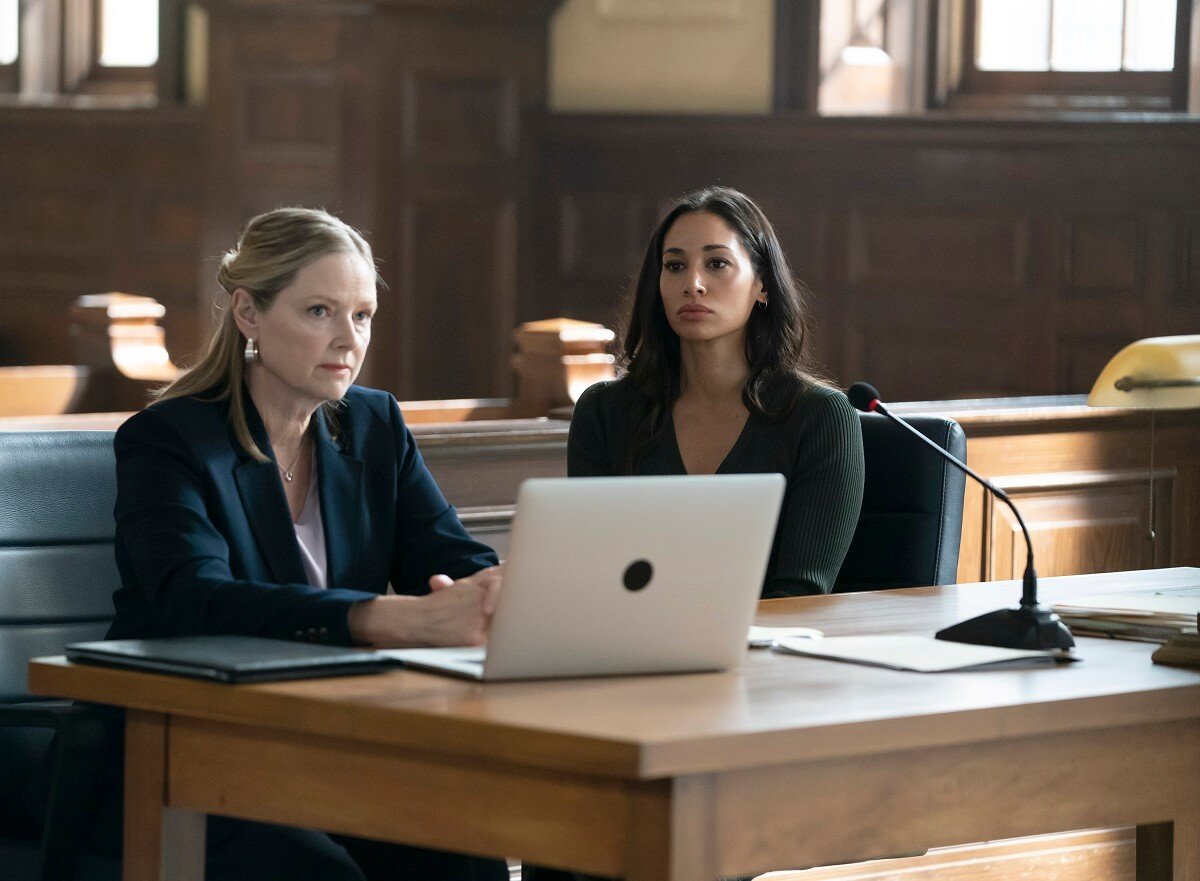 Accused Episode 12 cast members Allison Hossack as Kate and Meaghan Rath as Morgan sitting in a courtroom with a laptop.