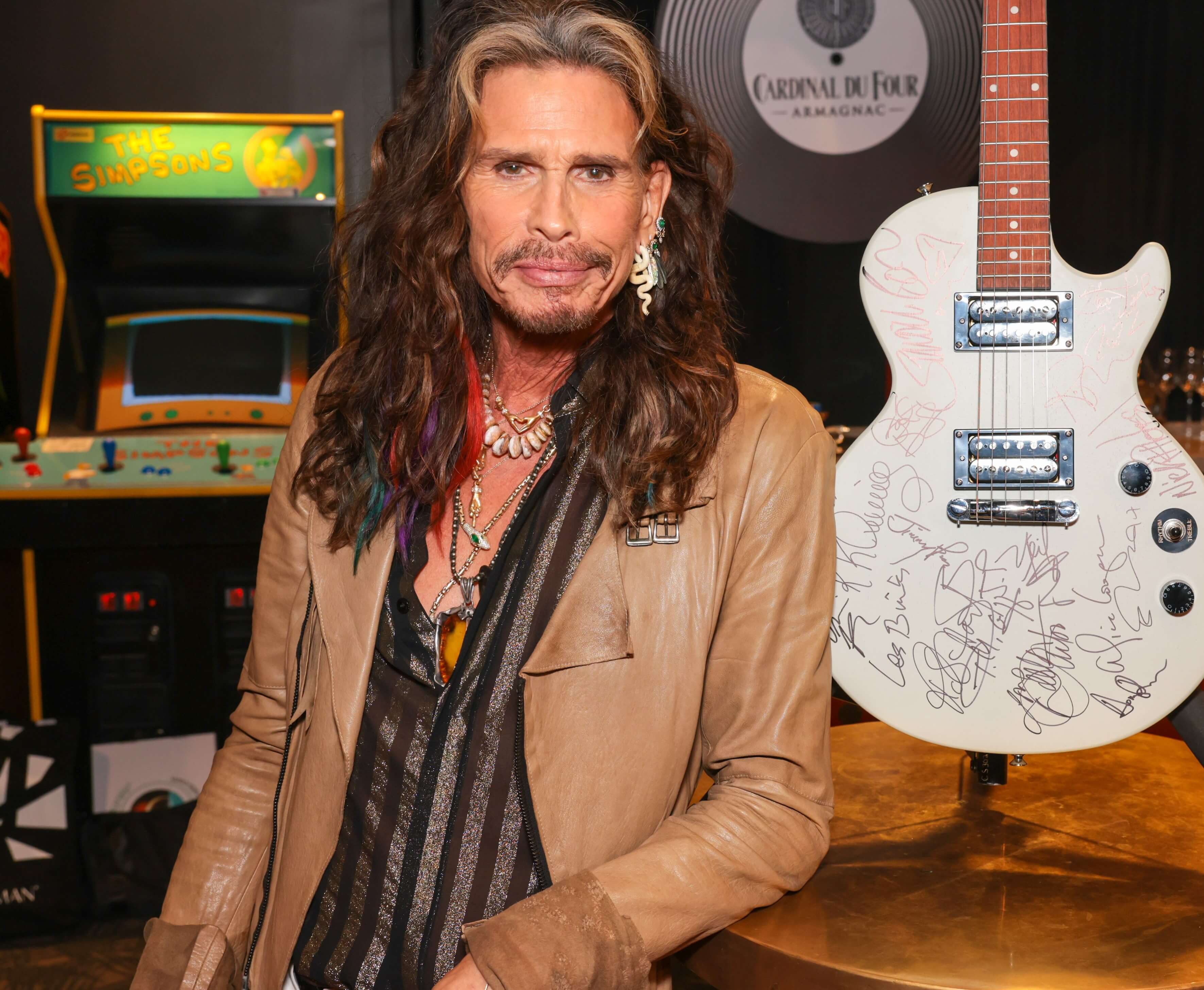 Aerosmith's Steven Tyler near a white guitar