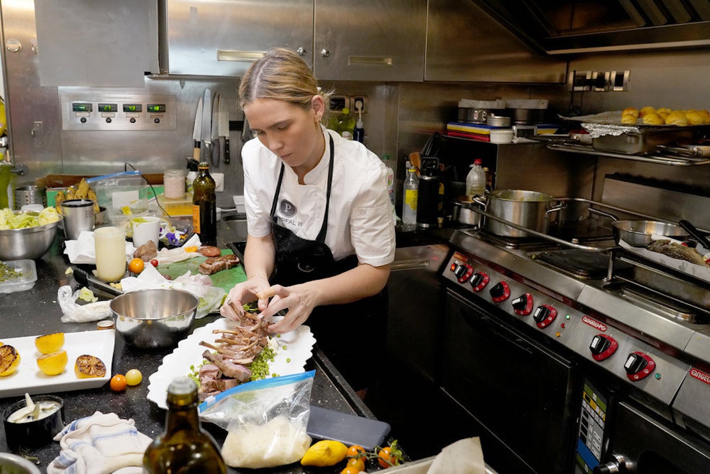 Chef Ileisha Dell prepares a meal in the 'Below Deck Sailing Yacht' galley