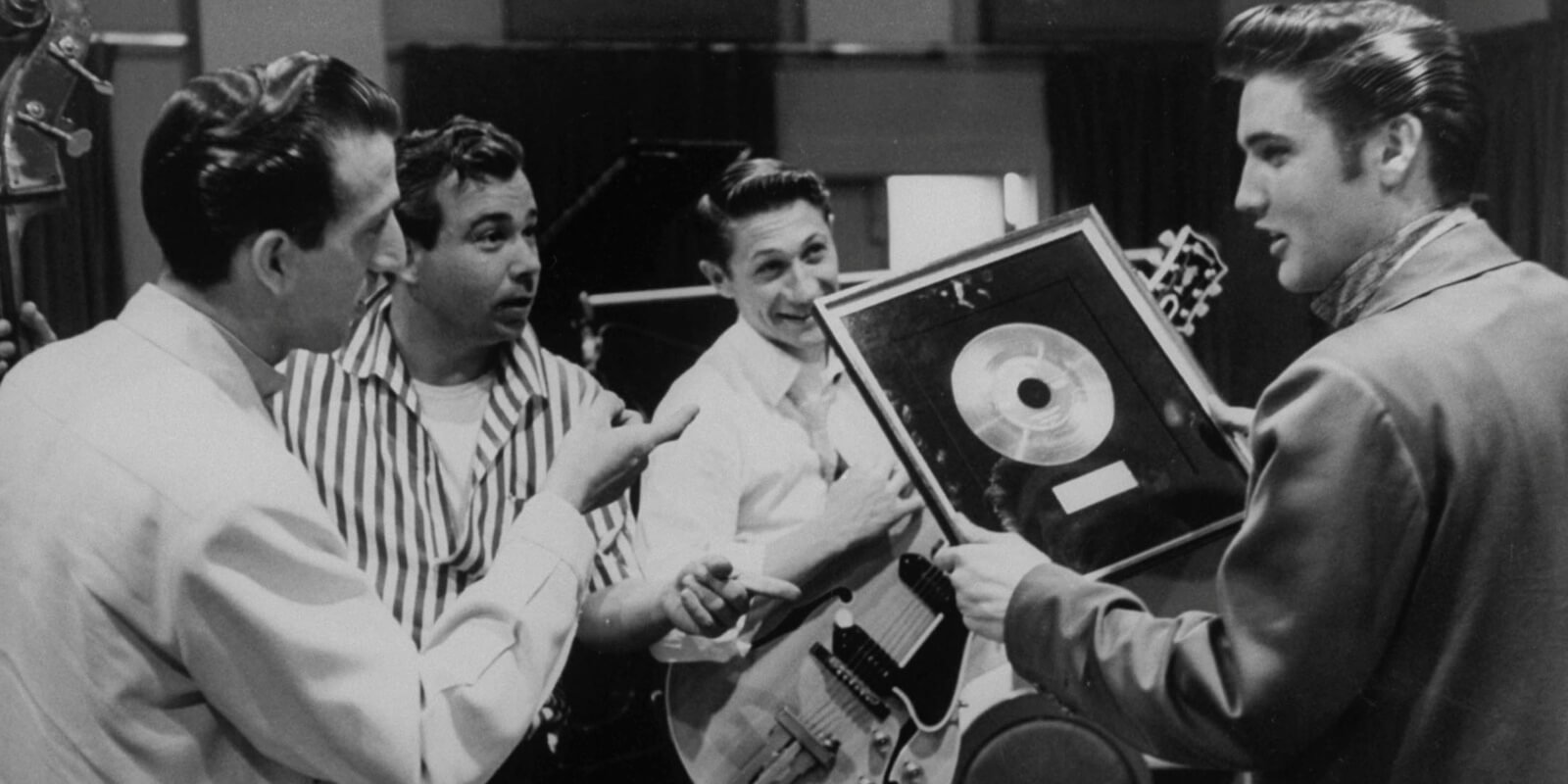 Elvis Presley was awarded a gold record for his 1956 hit 'Heartbreak Hotel' alongside band members D.J. Fontana, Gordon Stoker and Scotty Moore.