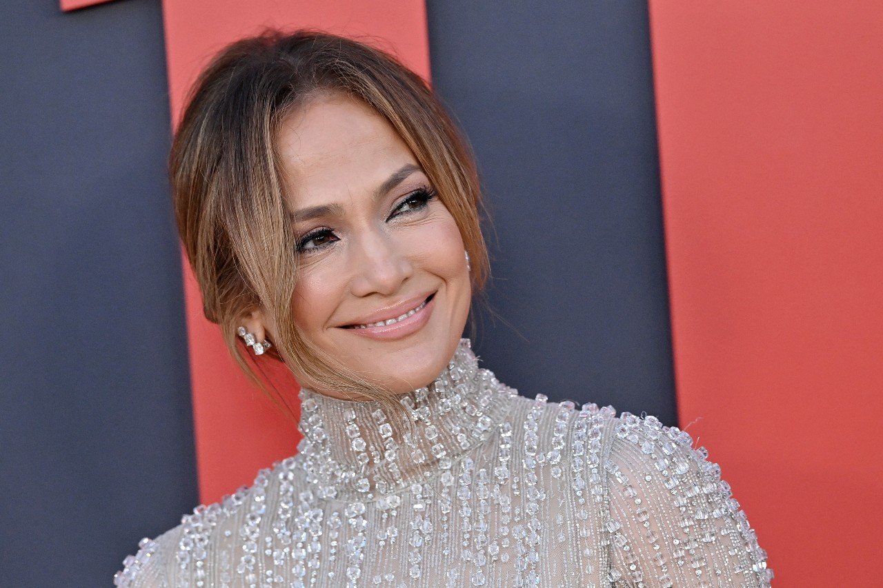 Jennifer Lopez wears a grey outfit with beads during an engagement.